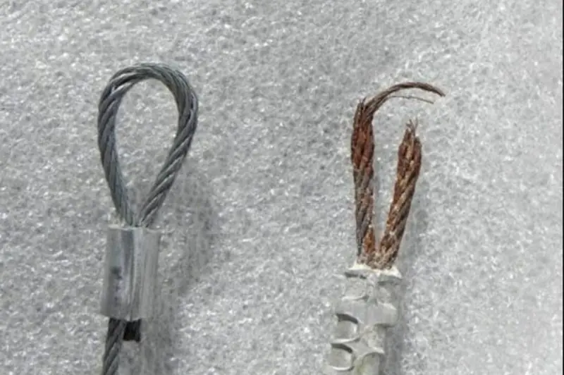 DPS Garage Doors comparison of a new garage door lifting cable beside a frayed snapped cable being replaced in Ottawa