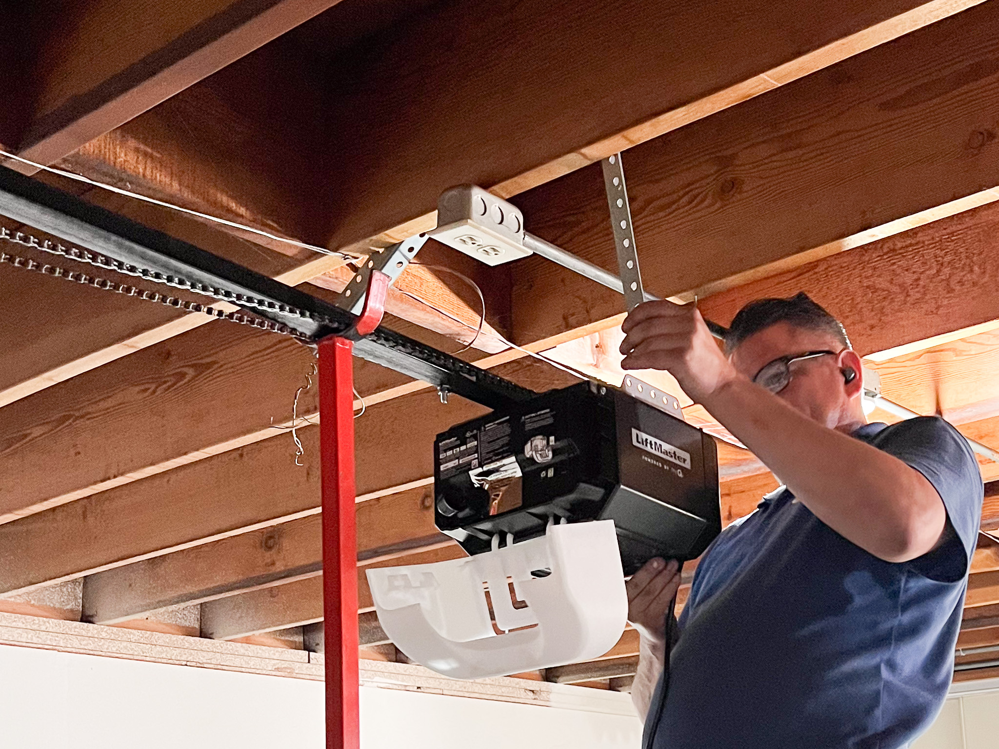 DPS Garage Doors technician installing a LiftMaster garage door opener in Ottawa