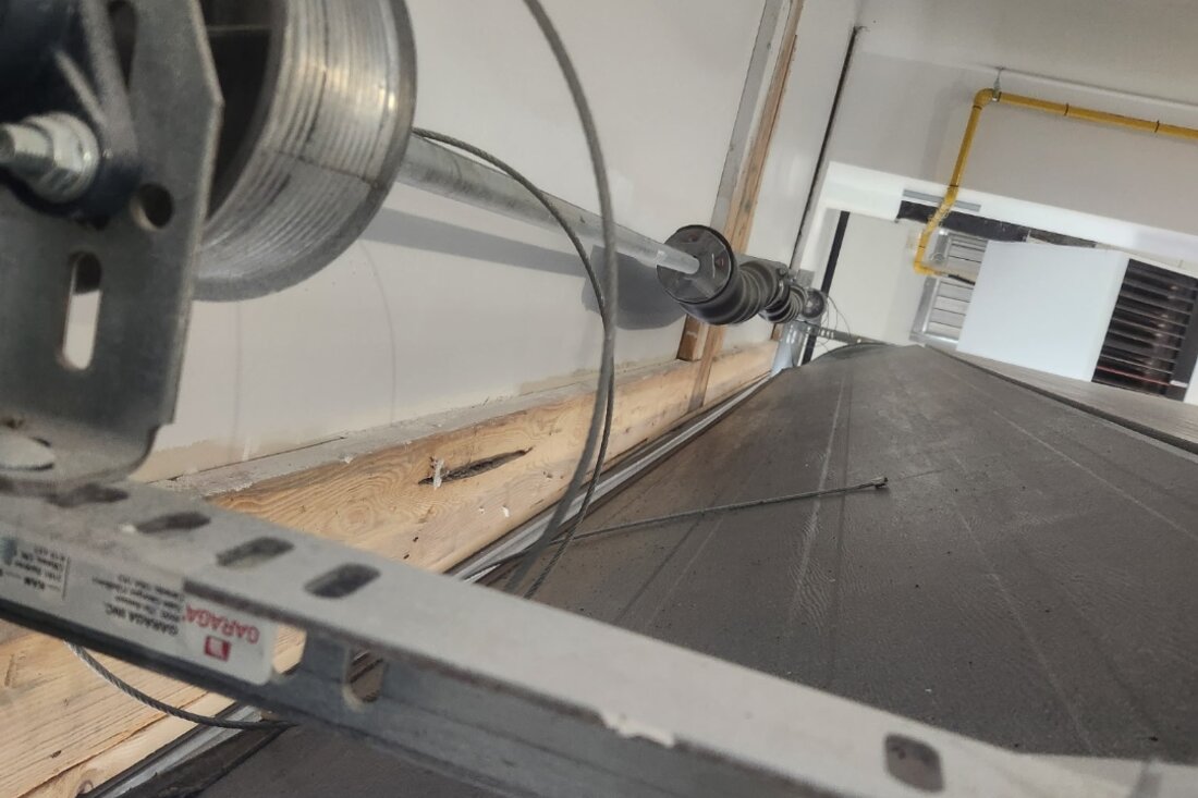 DPS Garage Doors repairing a garage door lifting cable at the cable drum on the torsion shaft in Ottawa