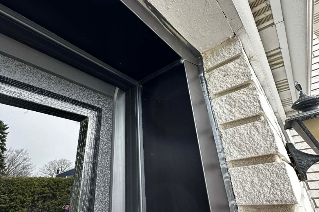 DPS Garage Doors custom-bent dark aluminum capping wrapping a garage door frame in Ottawa