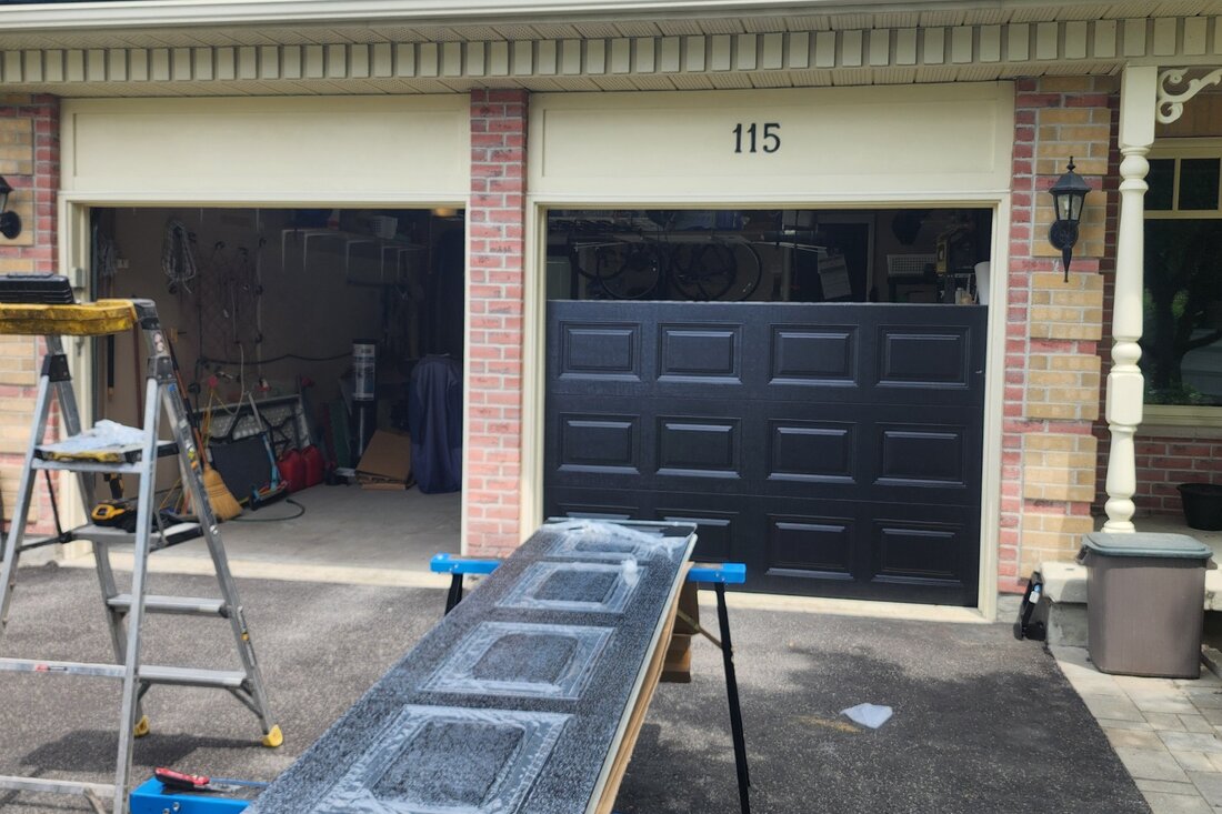 DPS Garage Doors installing a new dark insulated steel garage door in Ottawa