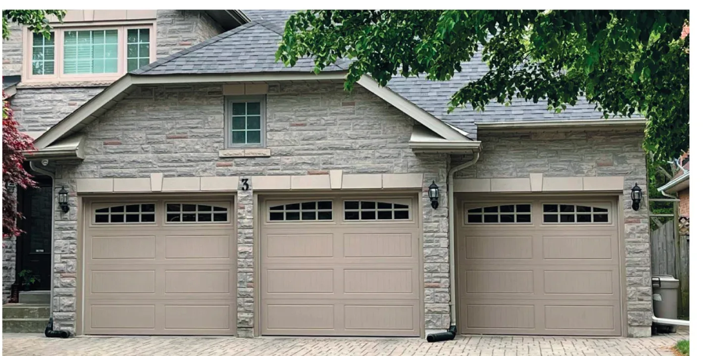 Ornate textured carriage-pattern garage door with deep panel detail