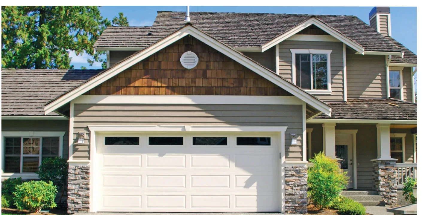 Long raised-panel insulated garage door on a Ottawa home